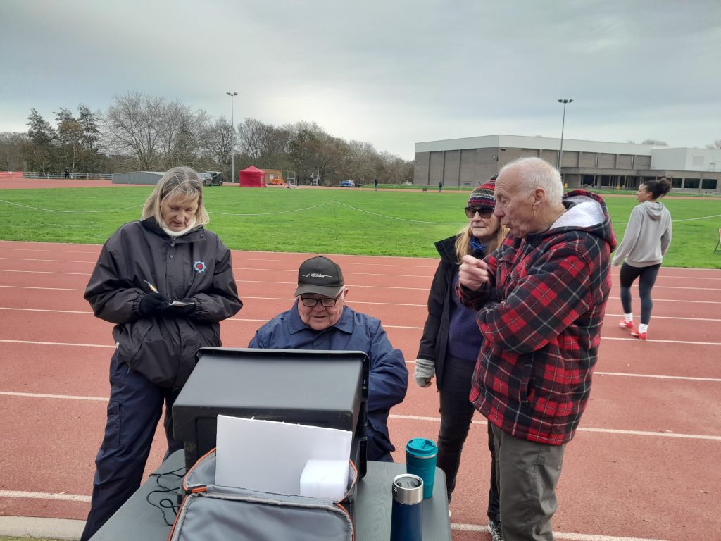 A group of KCAA field officials learning how to operate long jump take-off technology