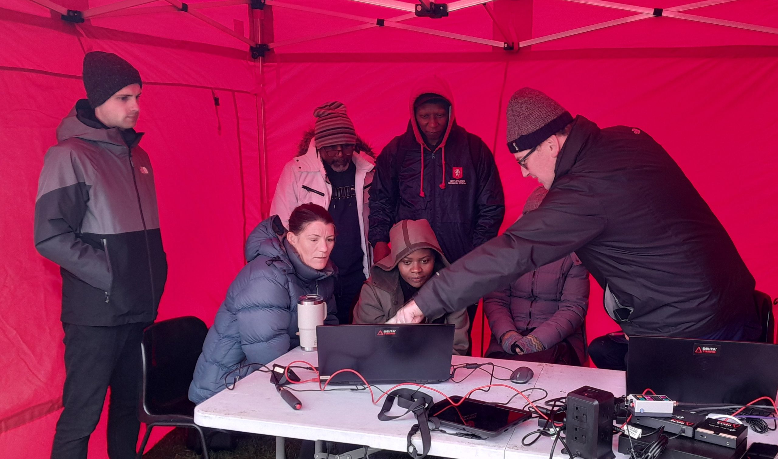 Team of officials aligning a photo finish camera