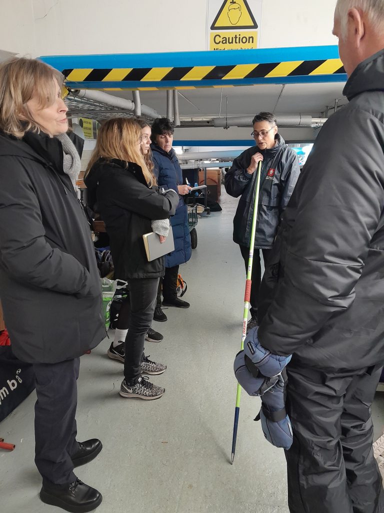 A group of KCAA field officials learning about hearing and checking field implement compliance