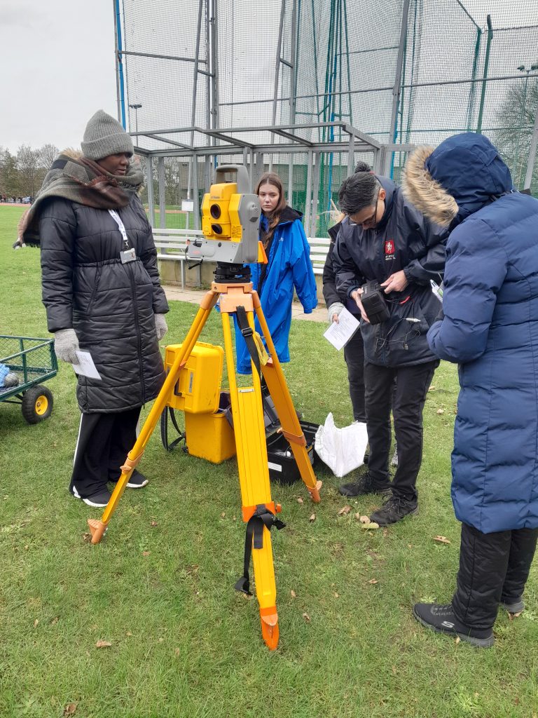 A group of KCAA field officials learning about setting up and using a EDM machine
